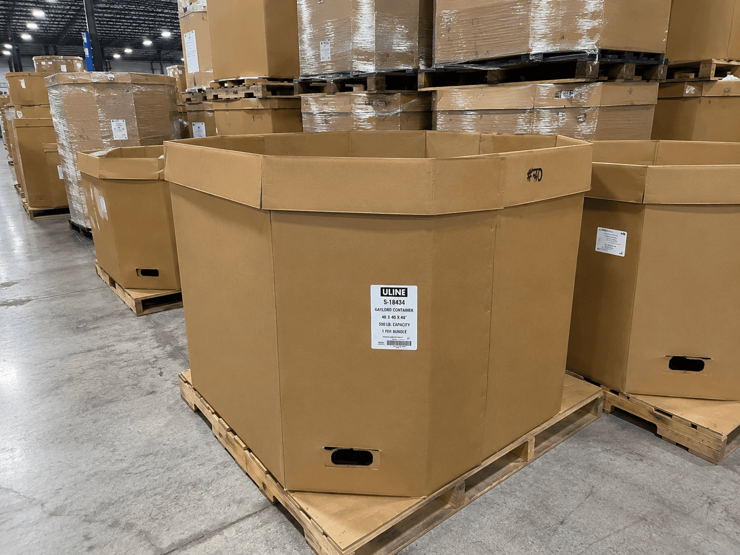 An octagonal bulk container (octabin) on a pallet in a distribution warehouse
